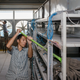 A janitor at the Bitmain mine mops the shelves hosting bitcoin mining machines.